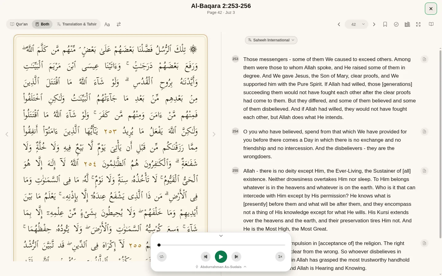 The mushaf on a desktop, the Arabic page on the left and numbered translations on the right.